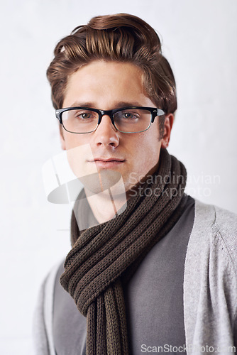 Image of Glasses, style and portrait of man by wall with casual, cool and trendy outfit for confidence. Serious, handsome and young male person with spectacles and fashion standing by white brick background.