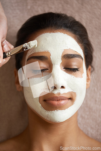 Image of Skincare, beauty and woman with face mask at spa for glow, wellness and natural routine with self care. Cosmetic, pamper and female person relaxing for clay facial dermatology treatment at salon.