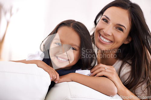 Image of Happy mother, portrait and hug with child on sofa for love, bonding or care together at home. Face of mom, parent and little girl, daughter or kid smile in living room for family weekend or support