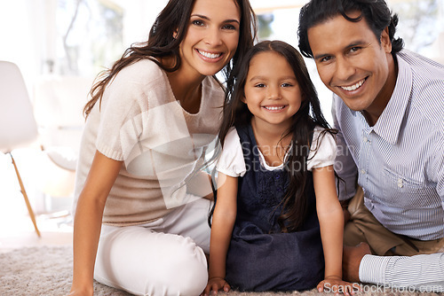 Image of Happy family, portrait and relax in home with love for bonding, support or care together. Face of mother, father and little girl, child or kid with smile on living room floor for holiday or weekend