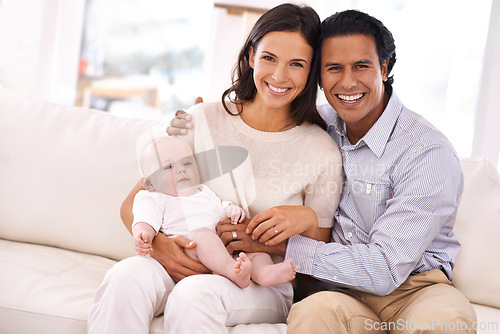 Image of Happy family, portrait and baby on sofa for bonding, holiday weekend or support together at home. Father and mother smile with young little child, kid or newborn toddler on living room couch at house