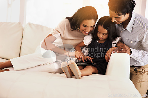 Image of Happy parents, child and tablet on sofa for entertainment, movie or bonding together at home. Mother, father and daughter on technology in relax for online streaming, series or reading ebook at house