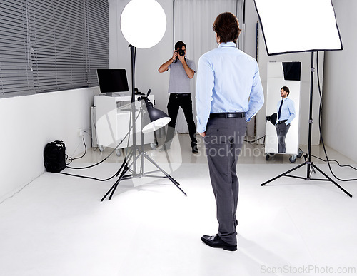 Image of Photographer, model and lighting with equipment in studio for career, behind the scenes or electronics. Photography, person or working with cameras, flash and shooting gear for photoshoot or passion