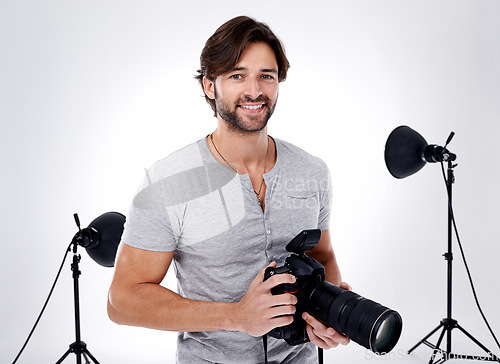 Image of Photography, portrait and happy with camera in studio for career, behind the scenes and backpack. Photographer, person or smile with equipment, mockup space or shooting gear for photoshoot or passion