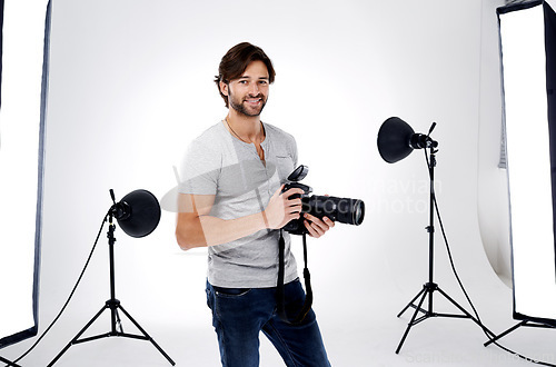 Image of Photographer, portrait and smile with camera in studio for career, behind the scenes and backpack. Photography, person or happy with equipment, mockup space or shooting gear for photoshoot or passion