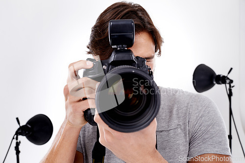 Image of Man, camera lens and photography with technology in studio, press or media for news on white background. Photographer, photo journalist and creative with paparazzi, equipment or gadget with closeup