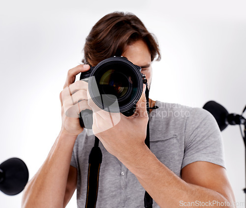 Image of Man, camera lens and photography with tech in studio, press or media for news on white background. Photographer, photo journalist and creative with paparazzi, equipment and closeup in studio
