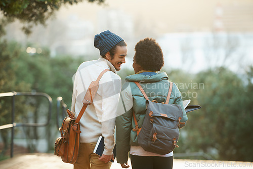 Image of College students, couple and walk in sunset, campus and bags for class and notebooks. Man, woman and smile for university, homework and cozy in winter season to study, embrace and date for academic