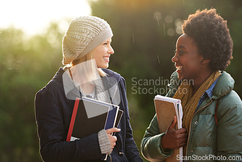 Image of College, books and conversation with woman friends outdoor on campus together for learning or development. Education, school or university with young student and best friend talking at recess break