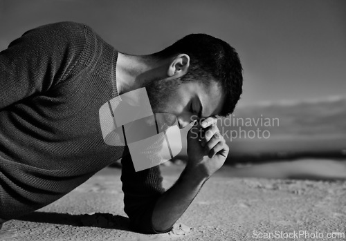 Image of Depression, sad or man in the desert thinking of travel in summer to relax on holiday vacation. Upset, black and white with face of male person on the ground with anxiety, monochrome or cool style