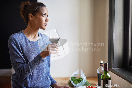 Image of Woman, red wine and thinking in kitchen, reflection and future, drink and food for cooking at home. Relax with alcohol in glass, inspiration or insight with memory, enjoy and wellness with beverage