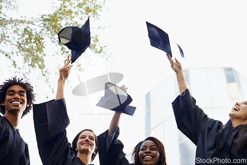 Image of Happy people, students and hats in celebration for graduation, winning or achievement at campus. Group of graduates throwing caps in air for certificate, education or milestone at outdoor university