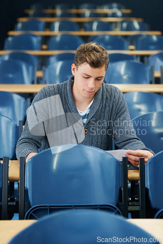 Image of Lecture hall, college and man with thinking, student and knowledge with exam and education. Person, writing and guy in classroom with test and learning with studying and creativity with research