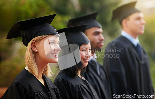 Image of Smile, graduation and woman student in line with friends at outdoor ceremony for college or university. Education, scholarship or achievement with graduate men and women at academic school event