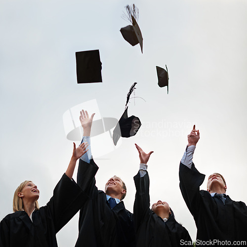 Image of Graduation, mortar and throw with student friends outdoor on campus for celebration at university ceremony. School, winner and air with graduate group together at college for success or achievement