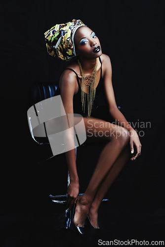 Image of Black woman, fashion and portrait with confidence, head dress and makeup in studio. Cosmetics, trendy and beauty with African female person from Kenya with traditional hair wrap with dark background