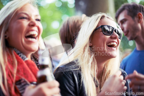 Image of Happy, drinks and women at music festival, concert or party laughing, excited and enjoy outdoor rave or techno celebration. Young friends, audience or crowd with beer bottle or alcohol for holiday