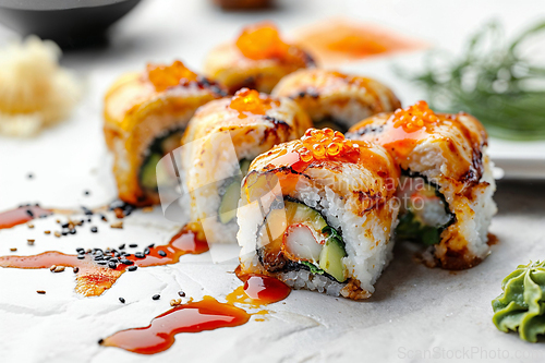 Image of Delicious Sushi Rolls with Savory Toppings and Sauce