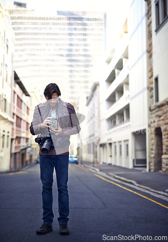 Image of Vintage, camera and photographer travel in city for photoshoot with gear to film on street. Creative, photography and cameraman working with retro lens to capture urban media outdoor on road