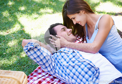 Image of Man, woman and relax in park for picnic on holiday for summer bonding, happy or outdoor. Couple, smile and embrace on blanket on grass for valentines day or dating connection or rest, love or weekend