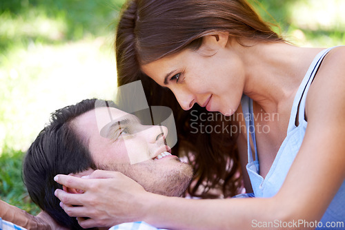 Image of Couple, smile and picnic on grass with embrace for bonding, love and sunshine in park outdoors. Happy, man and woman in love with intimacy for connection, romance and healthy relationship together