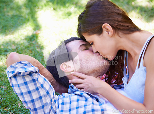 Image of Couple, kiss and picnic on grass for love, bonding and connection on holiday in park outdoors. Relax, man and woman with romance for healthy relationship, commitment and date on vacation in Miami