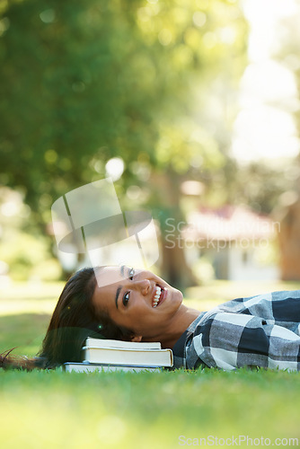 Image of Books, student and portrait of woman in park for studying, learning or reading outdoors. Education, knowledge and happy person with textbooks relax, rest and smile on grass for university or college