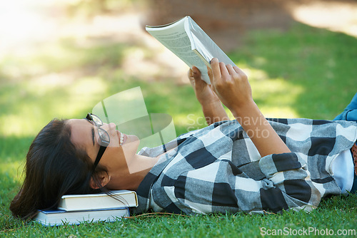 Image of Relax, grass or happy woman in park reading book for learning knowledge, information or education. Smile, textbook or student in nature for studying history, story or novel on college campus lawn