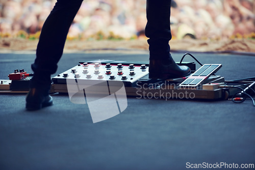 Image of Artist, stage and feet on equipment of instrument at concert, music festival or live event in Amsterdam. Performer, boots and pedal on platform for electric guitar for crowd, people and community