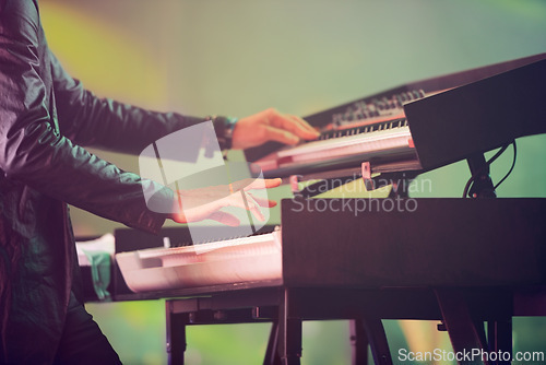 Image of Musician, keyboard synthesizer and hands at stage playing at concert, music festival or live event in Amsterdam. Artist, performance and amplifier at outdoor party for fun, enjoyment and celebration