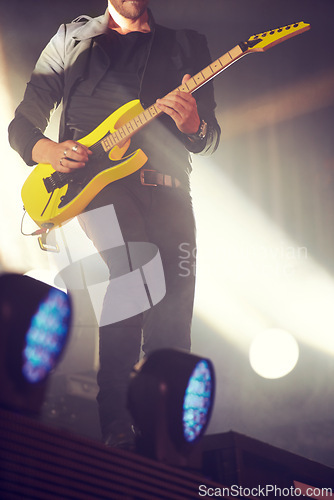 Image of Man, stage and guitar for performance at concert, music festival or live event in Amsterdam. Male artist, electric instrument and playing on stage for crowd, people or audience with enjoyment