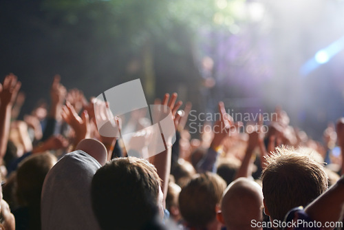 Image of Hands, people and crowd at music festival with dancing for rock party at concert with stage lights, nightclub or dj. Group, entertainment and holiday techno in summer for new years, adventure or rave