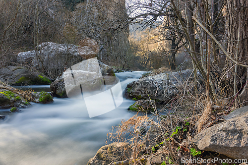 Image of beautiful wild water stream flowing through the rocks