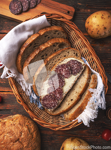 Image of Bread with butter and sliced salami