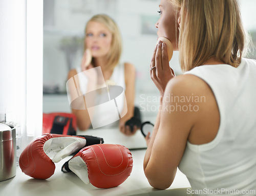 Image of Female person, bruise and boxing gloves by mirror, makeup and stylish outfit in dressing room. Woman, blush and eyeshadow for sport match, reflection and fashion to prepare for post interview