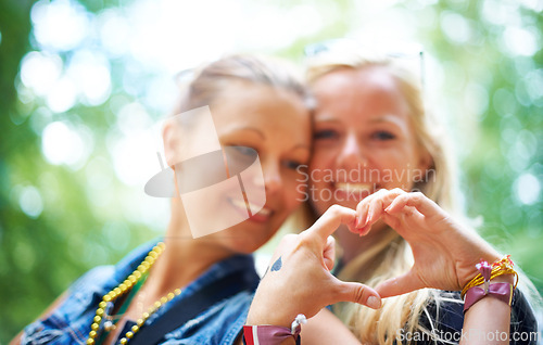 Image of Friends, heart gesture and smile at festival to party, celebrate and summer in California for bonding, enjoy and entertainment. Event, outdoor and happiness at concert with music for enjoyment