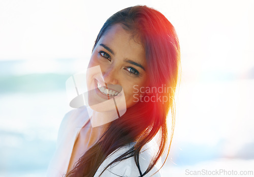 Image of Indian female person, beach and smile for ocean, waves and breeze for summertime in Bali for vacation. Woman, sea and holiday relaxation abroad with lens flare, sand and happy for memories and trip