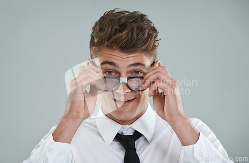 Image of Businessman, glasses and portrait in studio for optical healthcare, smile and confidence on gray backdrop. Male person, eyewear and proud of frame choice, optometry and lens for vision support