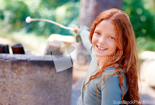 Image of Girl, smile and portrait by fire with marshmallow for camping adventure, summer and vacation for fun outdoors. Child, happy and face by barbecue with stick on holiday, outside and freedom to relax