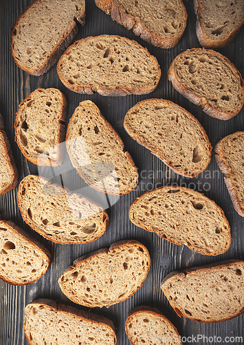 Image of Assorted sliced artisan bread on wooden background