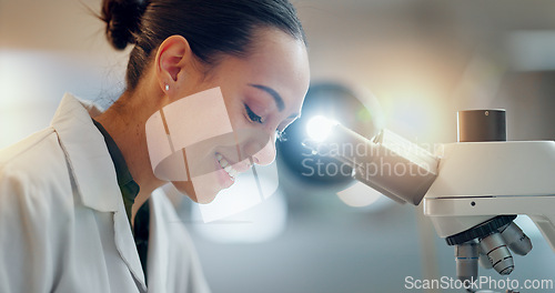Image of Laboratory, research and happy woman with microscope, future technology and biotech data in science. Medical innovation, scientist or lab technician in study for healthcare, medicine and vaccine test