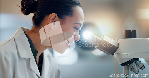 Image of Science, research and happy woman with microscope, technology or biotech data in laboratory. Medical innovation, scientist or lab technician in study in healthcare, medicine or pharmaceutical future