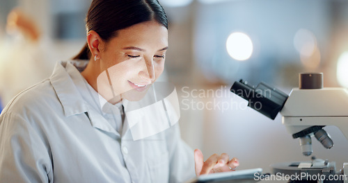 Image of Scientist, woman and tablet, microscope or laboratory research for DNA analysis and happy with medical study. Student or science expert in biotechnology with digital software and lens check for data