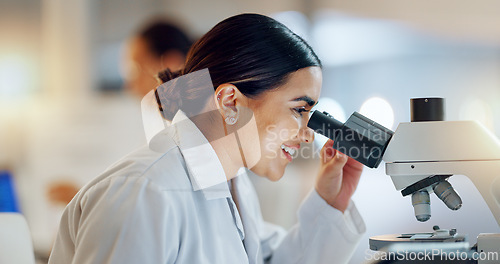 Image of Science, research and happy woman with microscope, technology or biotech data in laboratory. Medical innovation, scientist or lab technician in study in healthcare, medicine or pharmaceutical future