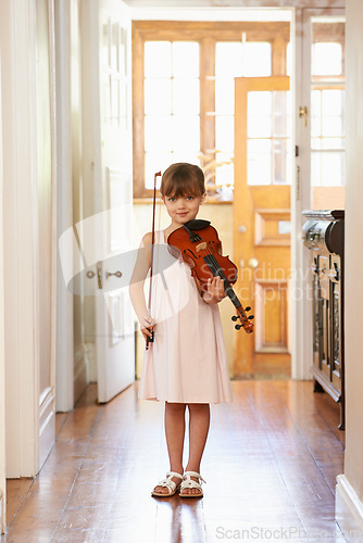 Image of Violin, girl and portrait of child in home for learning, practice or music education. Art, fiddle and student with bow for talent, creative or hobby in house with acoustic string instrument in Canada