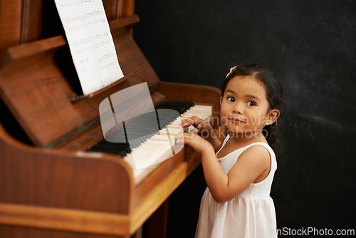 Image of Piano, girl and baby in home for learning, practice and classical education with musical notes. Training, melody and kid with talent, creative or hobby with instrument, child development or skill