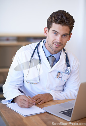 Image of Doctor, laptop and notebook with pen at desk for telehealth, appointment or patient report in office. Man, technology and writing on paper for planning, communication or health insurance in hospital