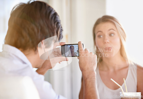 Image of Couple, phone and photography for blog, memories and happiness with silly face at home on valentines day. Man, woman and photo in house, hotel and vacation for weekend getaway and romantic vlog