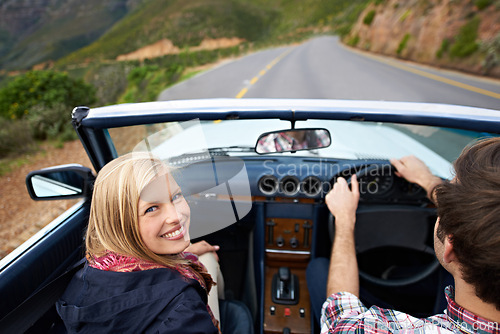 Image of Couple, driving and convertible steering wheel on mountain from behind for vacation happy, adventure or holiday. Man, woman and portrait on transportation in California for travel, relax or nature