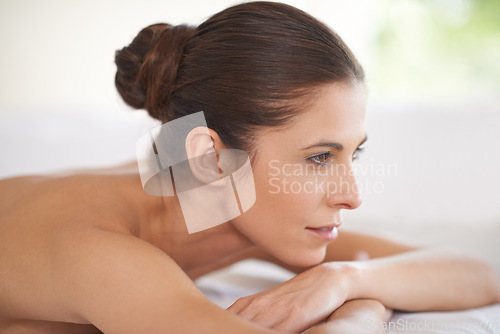 Image of Luxury, spa and woman relax on table for skin care or treatment for beauty in hotel on holiday or vacation. Calm, person and girl on bed in salon or resort with wellness and healthy stress relief